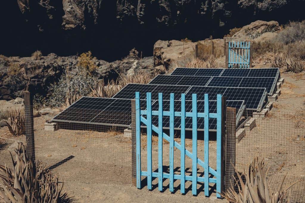 Solar panels set in an arid landscape of Alajeró, reflecting renewable energy efforts in Canary Islands.
