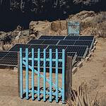 Solar panels set in an arid landscape of Alajeró, reflecting renewable energy efforts in Canary Islands.