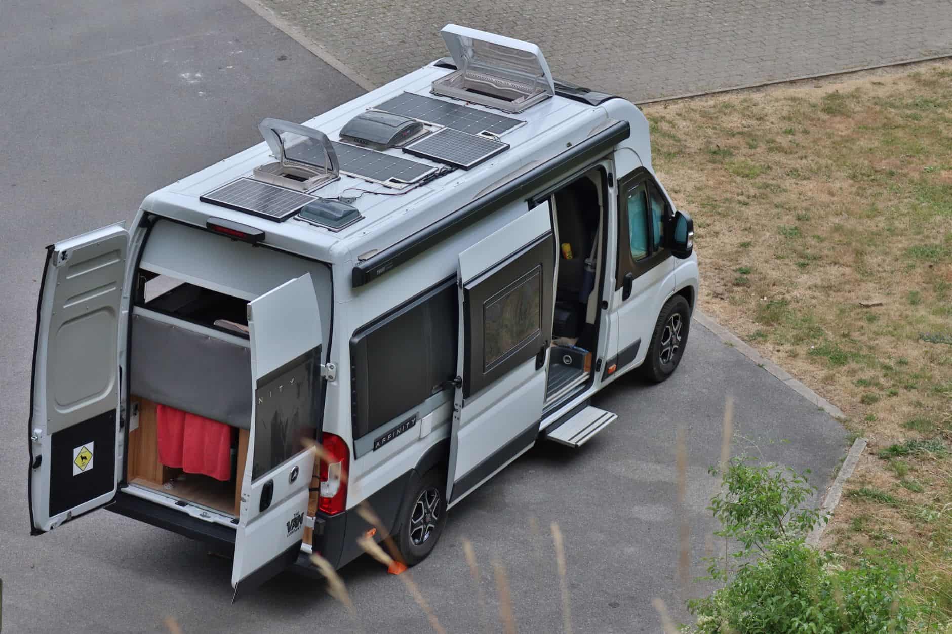 Top view of a campervan parked outdoors with solar panels, symbolizing vanlife in Bouillon, Belgium.